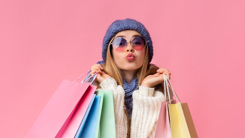 Woman with shopping bags happy with her discounted purchase